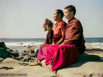 (15851_ng.tif) Lama Yeshe with Yeshe Khadro and Chamba Lane meditating by the ocean, Maroochydore, Australia, 1974. The lamas took a day off during the Diamond Valley course to go to the beach in Tom Vichta's van. Everyone got out to enjoy the view from the cliffs, but Lama Yeshe ran straight down to the water's edge, hitched up his robes, and waded in, splashing about with delight.