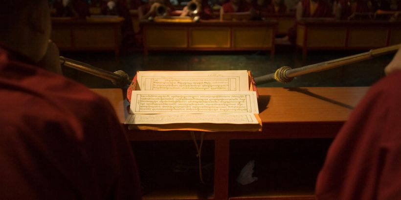Buddhist monks reading and chanting sutras at the Vajra Vidya Institute for Buddhist studies in Sarnath, India